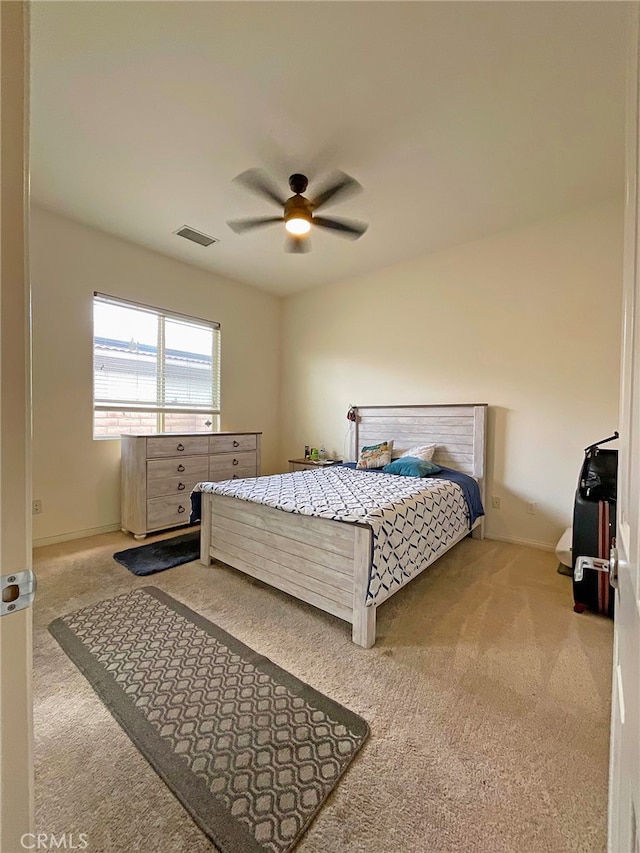 bedroom featuring light carpet and ceiling fan