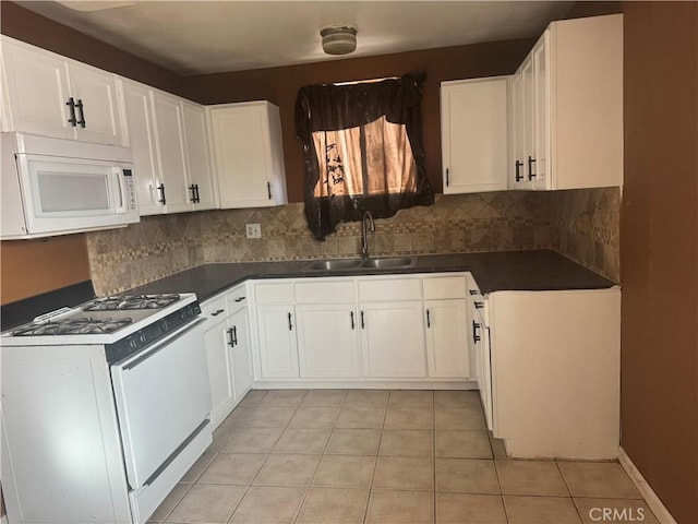 kitchen with white cabinetry, sink, and white appliances