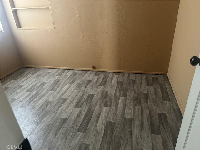 empty room with hardwood / wood-style floors