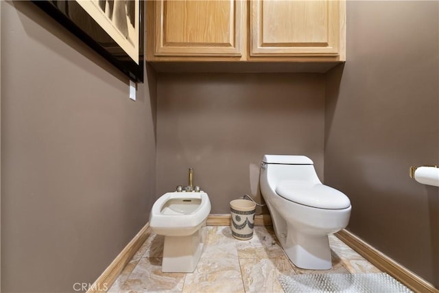 bathroom featuring a bidet and toilet