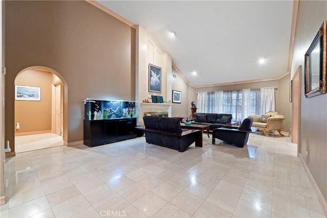 living room with light tile patterned floors, crown molding, a fireplace, and high vaulted ceiling