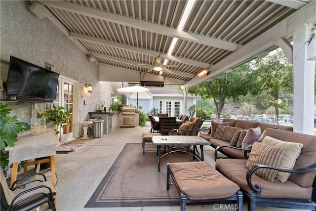 view of patio with a grill, area for grilling, an outdoor hangout area, ceiling fan, and french doors