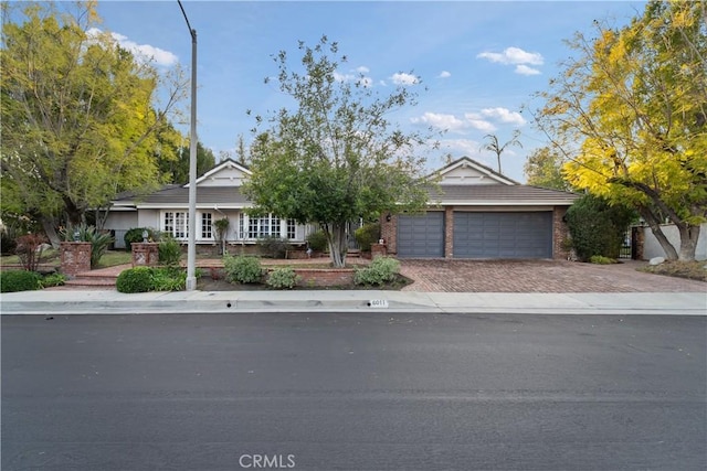 6011 Paseo La Vis, Woodland Hills, CA 91367 - view of front of house featuring an attached garage and decorative driveway