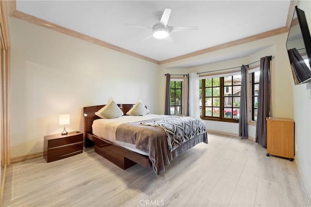 bedroom featuring ceiling fan, ornamental molding, and light hardwood / wood-style flooring