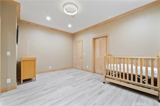 unfurnished bedroom featuring ornamental molding and light hardwood / wood-style floors