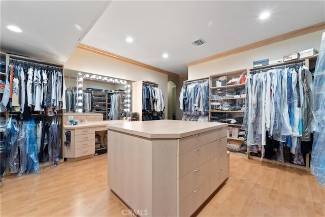 walk in closet with light wood-type flooring