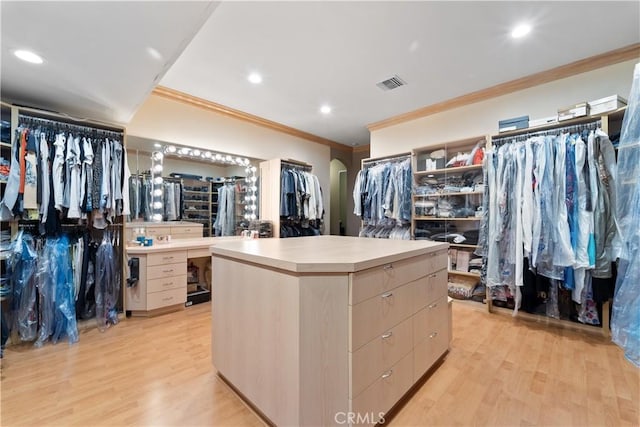 6011 Paseo La Vis, Woodland Hills, CA 91367 - walk in closet with light wood-style floors, arched walkways, and visible vents