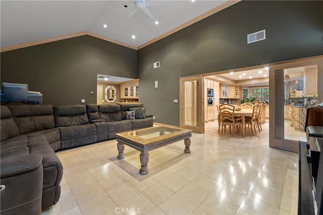 tiled living room with crown molding, ceiling fan, and high vaulted ceiling