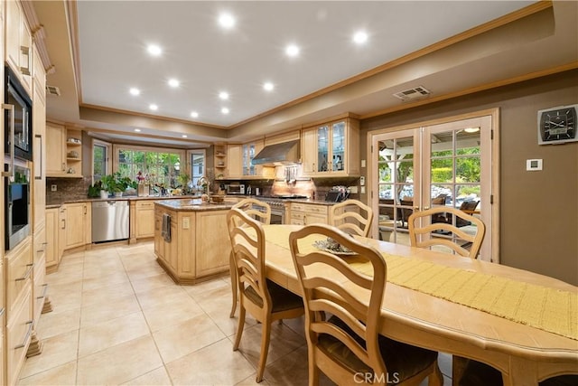 tiled dining space with crown molding, a raised ceiling, and french doors