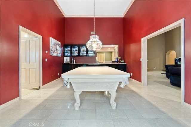 playroom featuring a towering ceiling, billiards, and light tile patterned floors