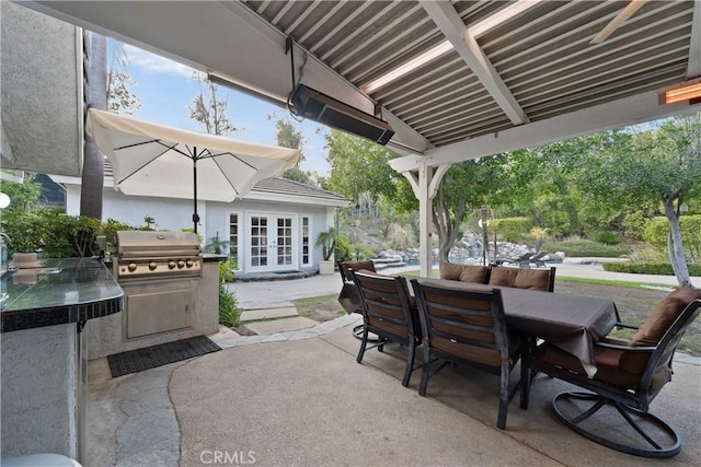 view of patio / terrace with french doors, a grill, and exterior kitchen