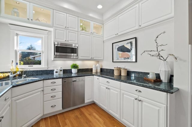 kitchen featuring white cabinetry, stainless steel appliances, light hardwood / wood-style floors, and sink