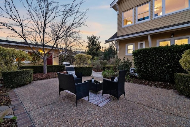 patio terrace at dusk featuring outdoor lounge area