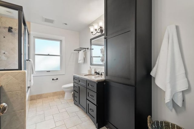 bathroom featuring walk in shower, vanity, toilet, and a notable chandelier