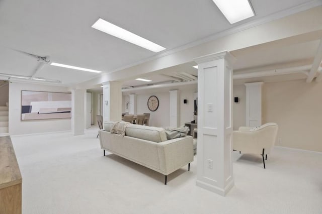 carpeted living room with ornamental molding and ornate columns