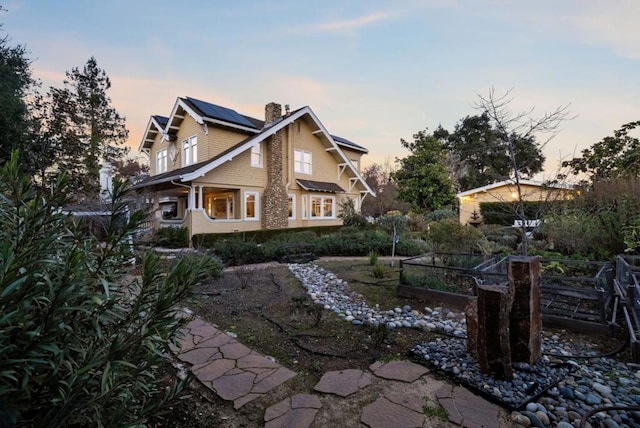 back house at dusk with solar panels