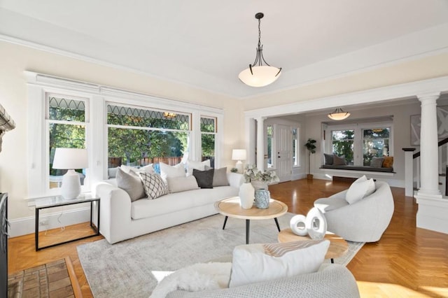 living room with ornate columns, ornamental molding, and parquet floors