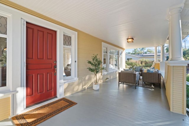 view of exterior entry with covered porch