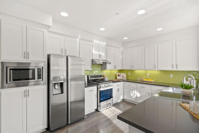 kitchen featuring sink, white cabinetry, tasteful backsplash, appliances with stainless steel finishes, and dark hardwood / wood-style flooring