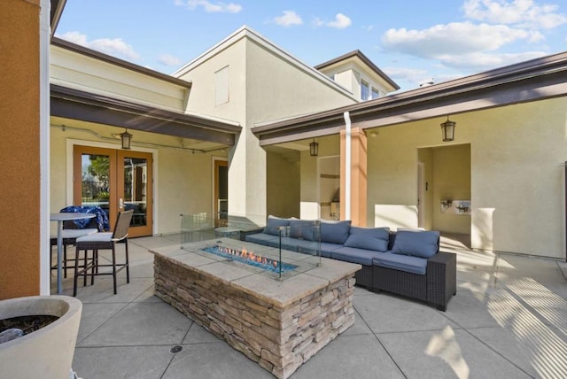 view of patio featuring french doors and an outdoor living space with a fire pit