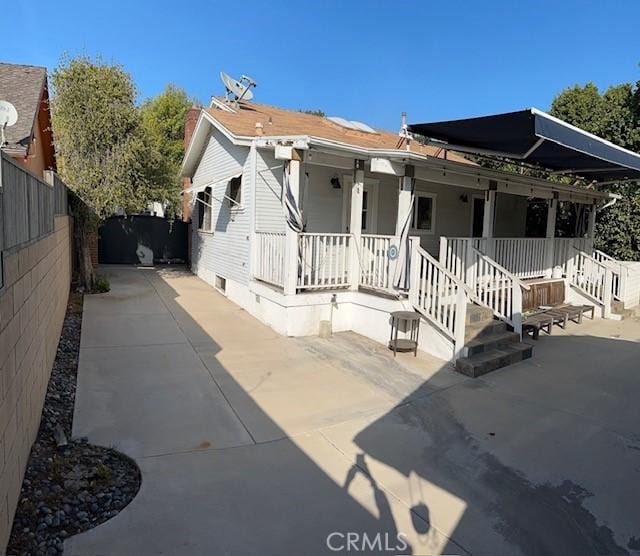 1886 Wagner St, Pasadena, CA 91107 - view of front of house with fence, a porch, a chimney, and a patio area