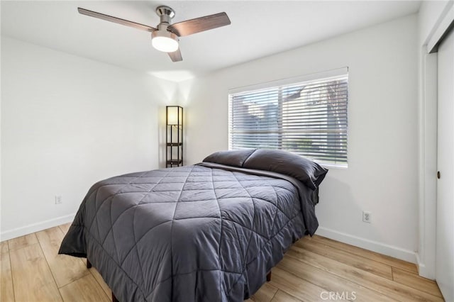 bedroom with ceiling fan and light wood-type flooring