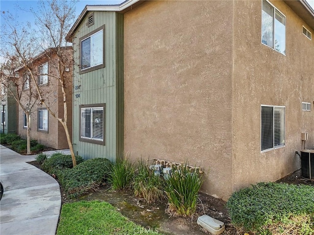 view of side of property with central AC unit