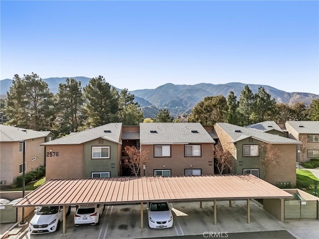 rear view of property with a carport and a mountain view