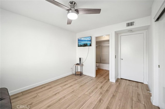 unfurnished bedroom featuring ceiling fan, light hardwood / wood-style floors, and a closet