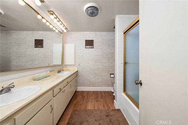 bathroom with vanity, hardwood / wood-style floors, and combined bath / shower with glass door