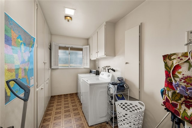 clothes washing area with cabinets and washer and dryer