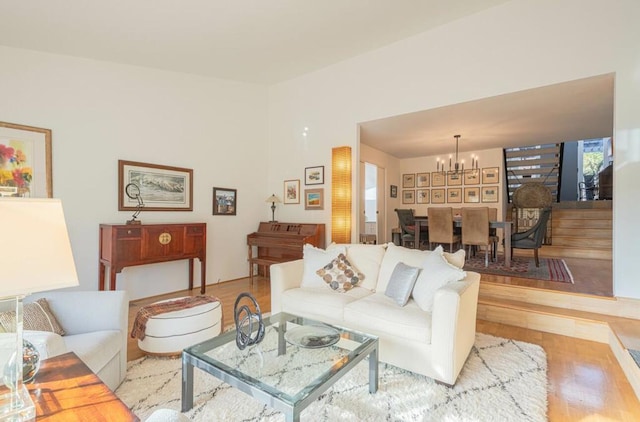 living room with light wood-type flooring and a chandelier