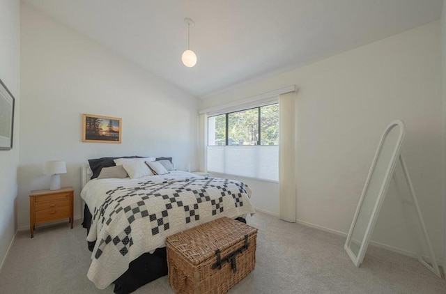 carpeted bedroom with vaulted ceiling