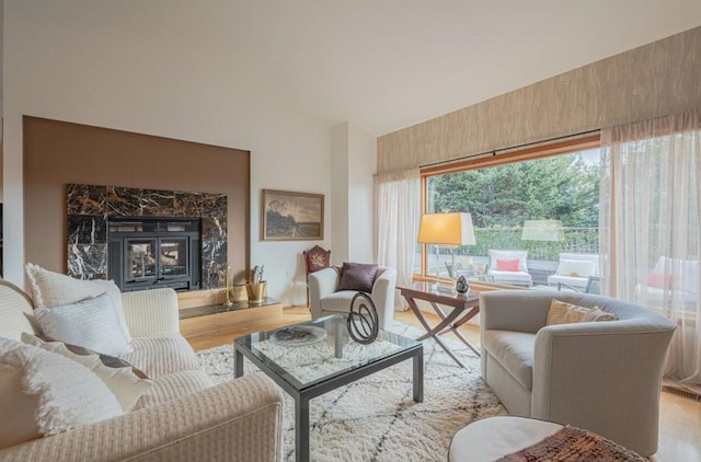 living room with a premium fireplace and light wood-type flooring