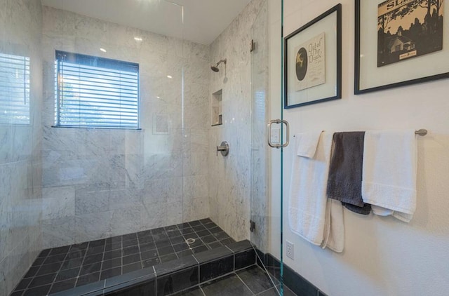 bathroom featuring a shower with door