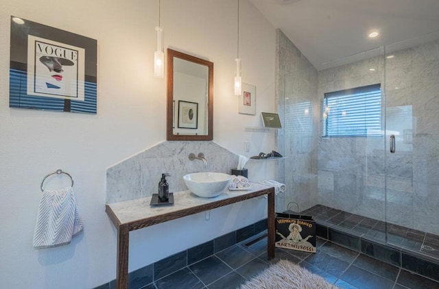 bathroom featuring sink and a tile shower