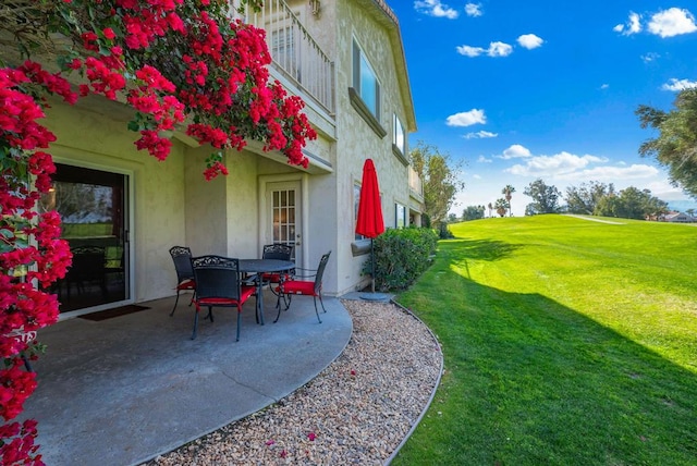 view of yard featuring a balcony and a patio area