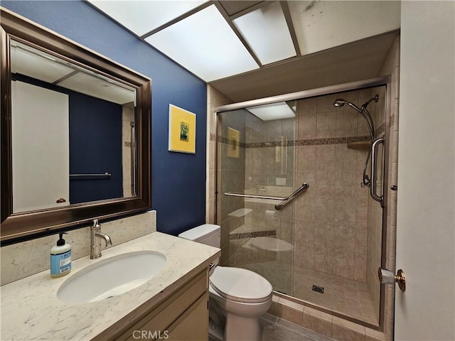 bathroom with vanity, an enclosed shower, and toilet