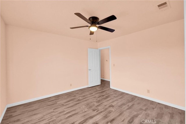 empty room with hardwood / wood-style floors and ceiling fan