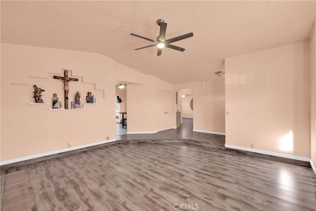 unfurnished living room featuring hardwood / wood-style flooring, lofted ceiling, and ceiling fan