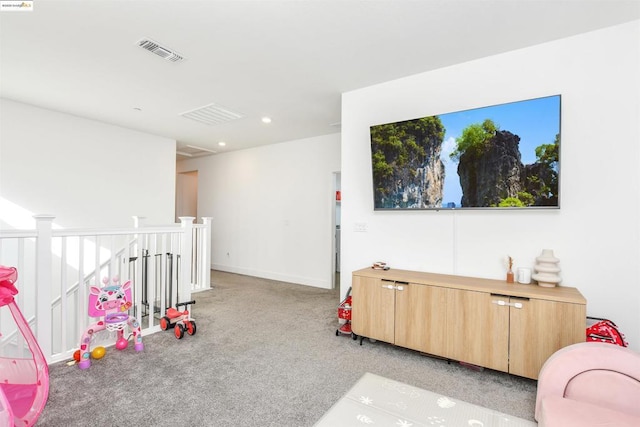 recreation room featuring light colored carpet