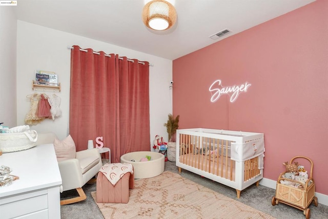 carpeted bedroom with a nursery area