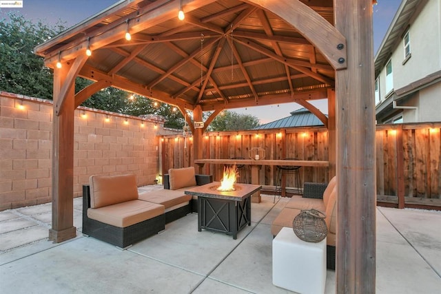 view of patio featuring a gazebo and an outdoor living space with a fire pit