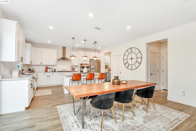 dining area featuring light hardwood / wood-style floors and sink