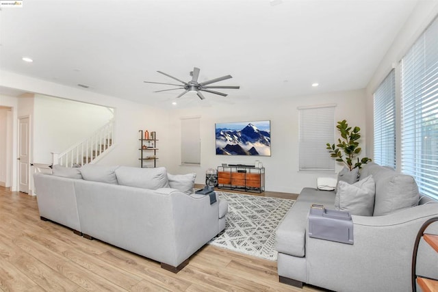 living room featuring ceiling fan and light hardwood / wood-style floors