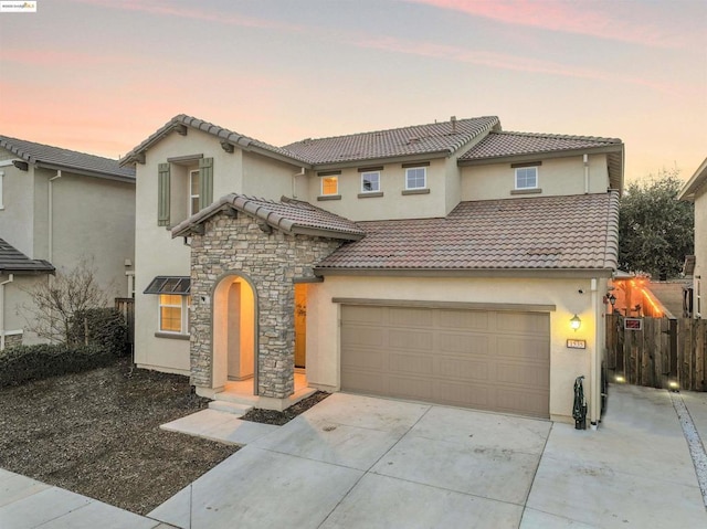 mediterranean / spanish-style home featuring a garage