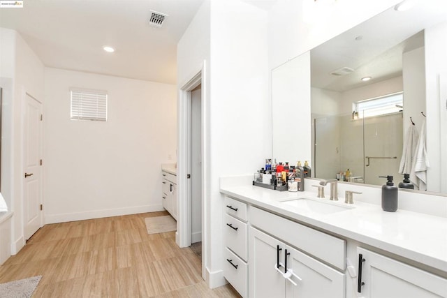 bathroom with vanity and an enclosed shower