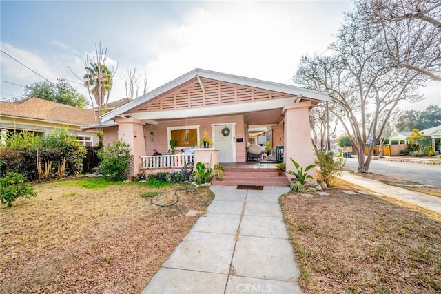 bungalow-style home with a front yard and a porch