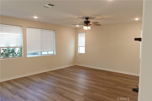 spare room featuring dark hardwood / wood-style flooring and ceiling fan