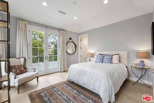 bedroom with light hardwood / wood-style flooring, access to outside, and french doors